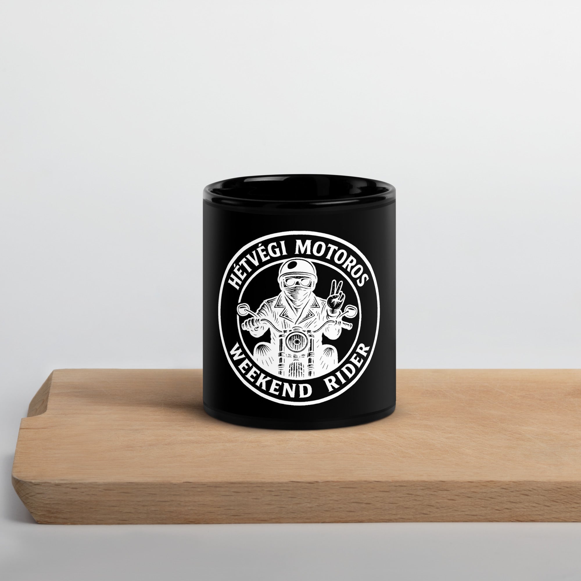 Black mug with white graphic and text on a wooden surface