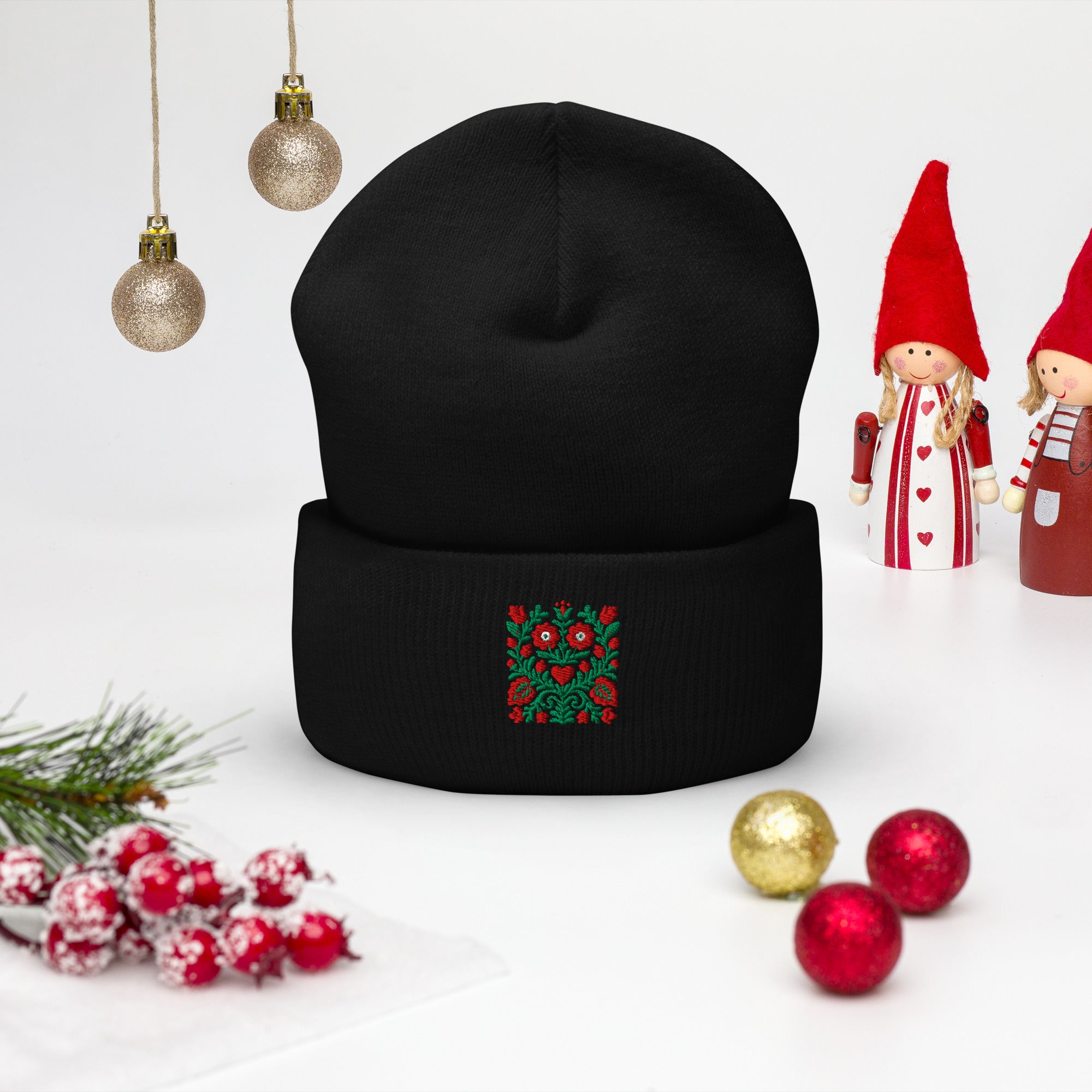 Black beanie with embroidery on a white background with Christmas decorations