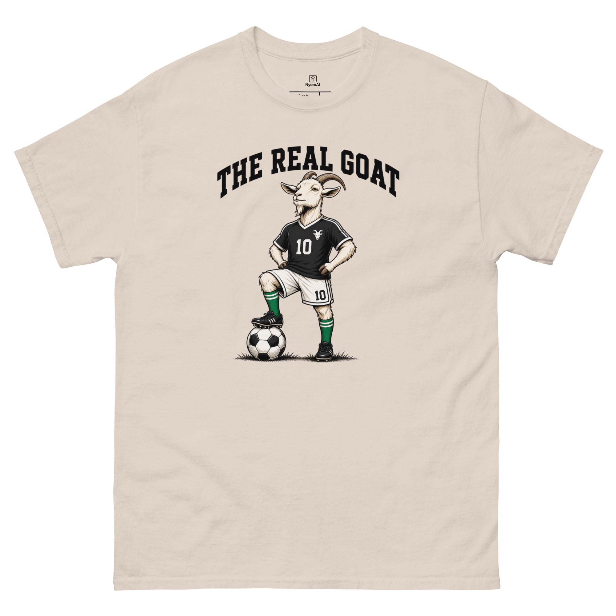Beige t-shirt with a graphic of a goat playing soccer and 'The Real Goat' text on a white background.