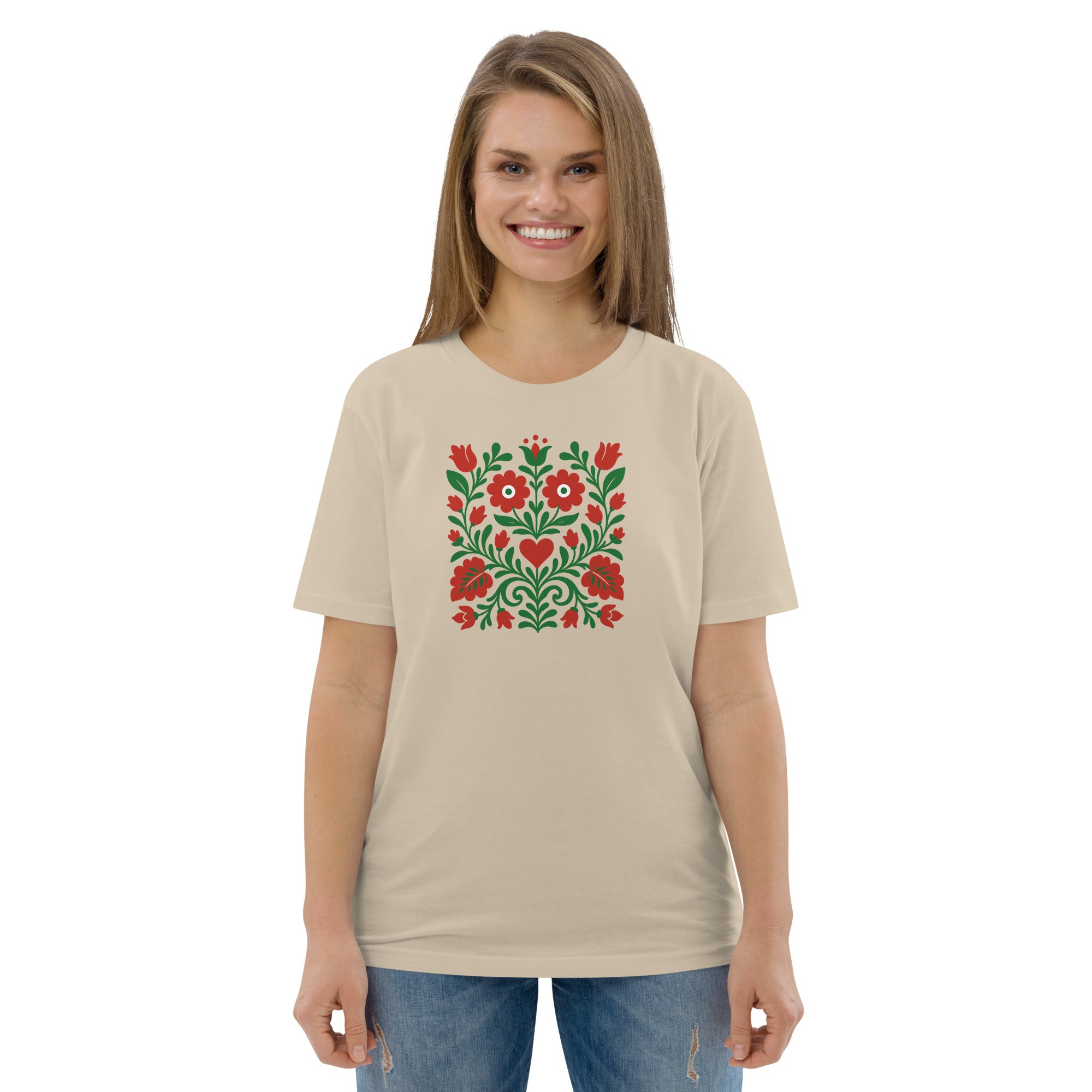 Woman wearing a beige t-shirt with a red and green floral pattern on a white background