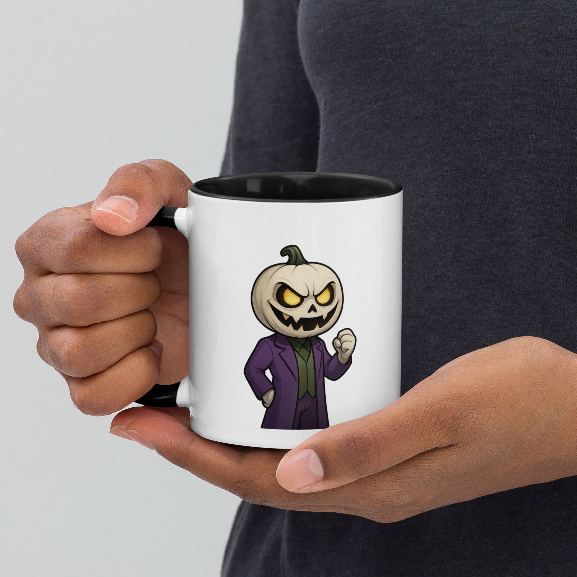 Person holding a mug with a cartoon pumpkin character in a suit on a white background