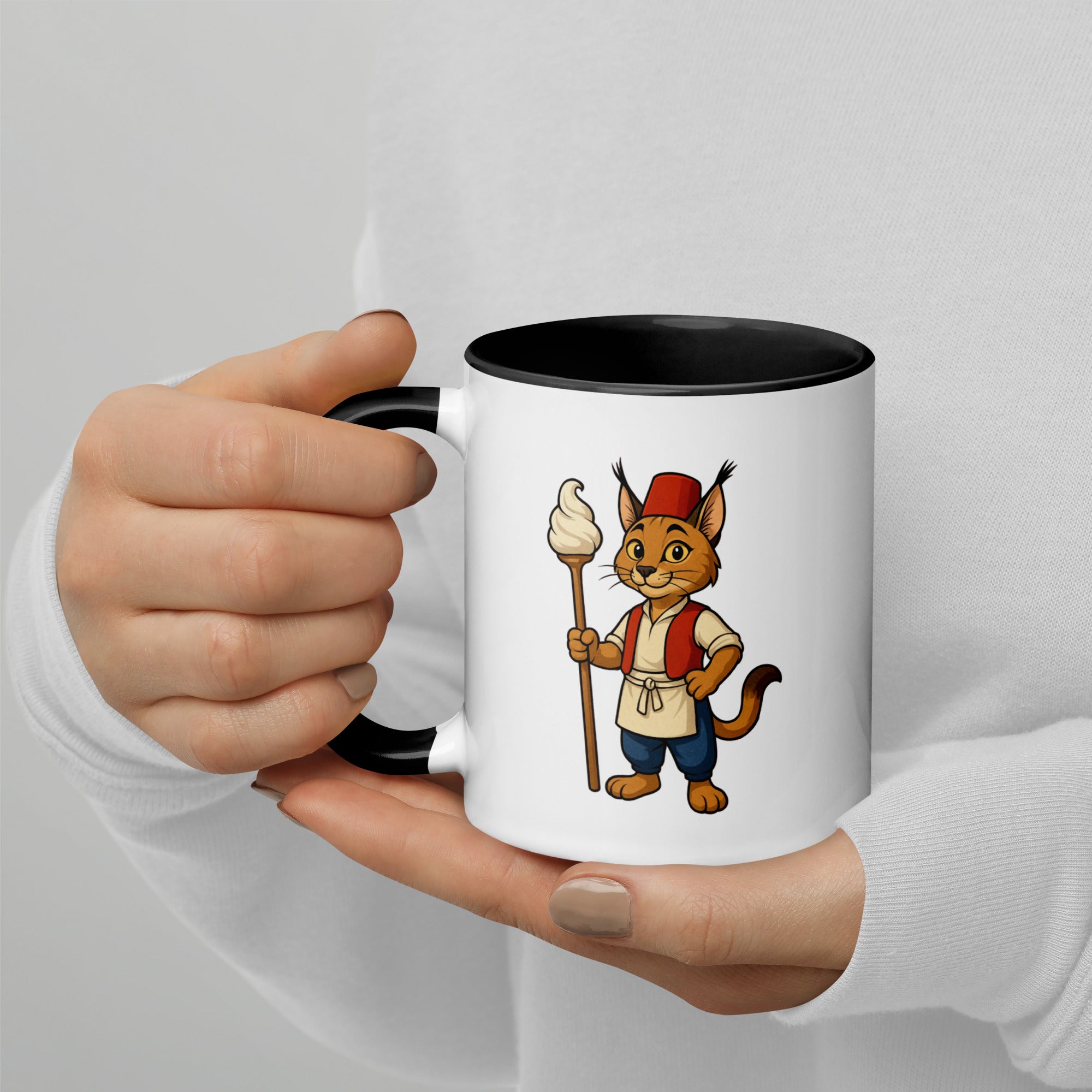 Mug with cartoon character holding a stick and ice cream, held by a person against a light gray background