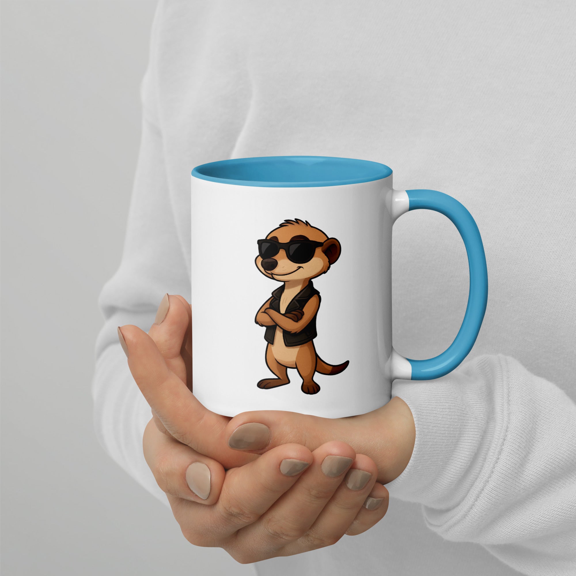 Person holding a mug with a cartoon character design on a plain background