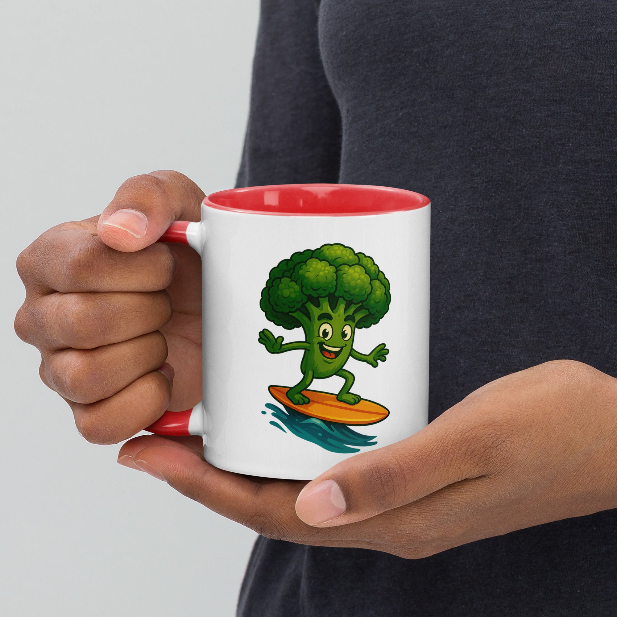 Fun ceramic mug with a cartoon broccoli surfing, featuring a red interior and handle.