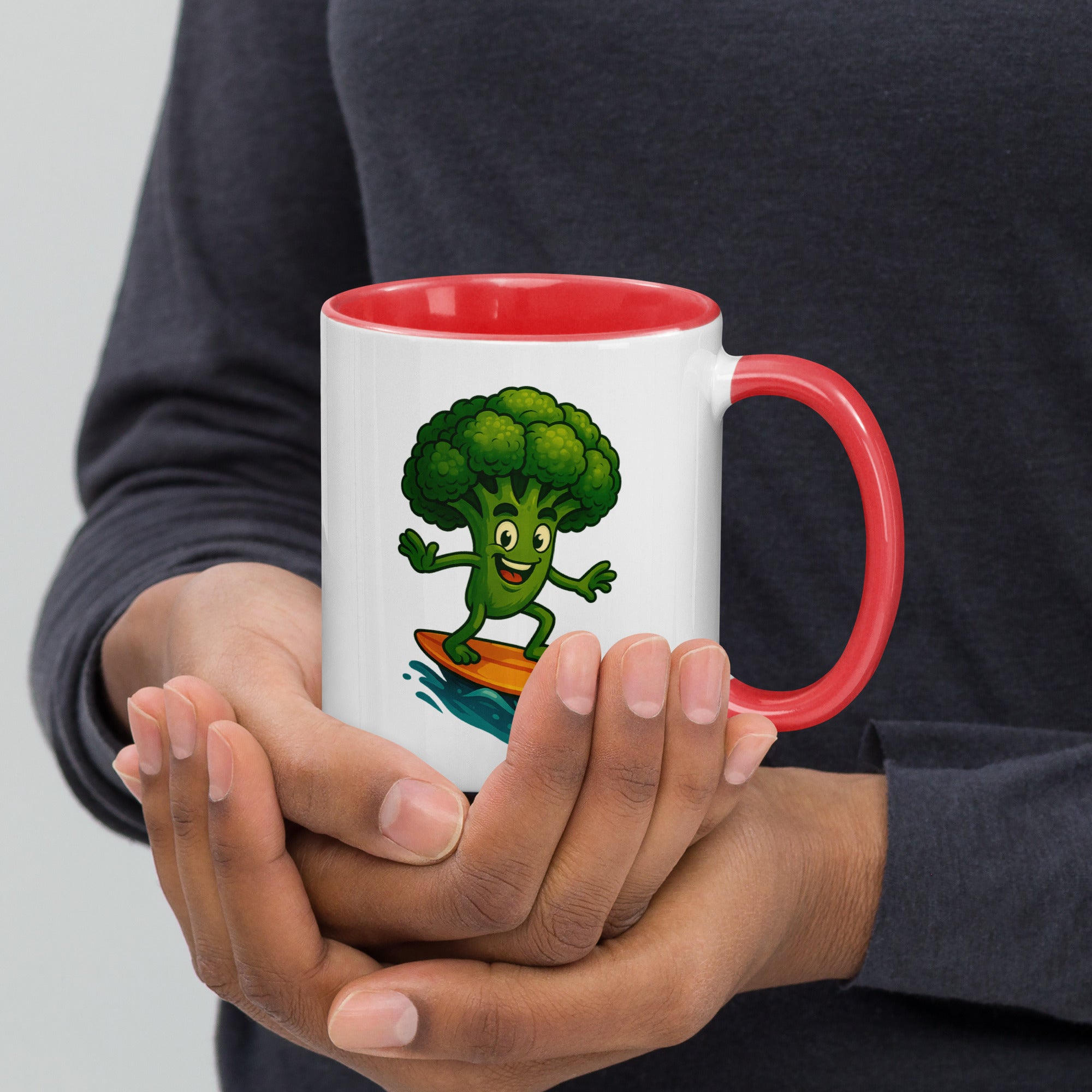 Colorful ceramic mug featuring a cheerful broccoli character, held in hands, perfect for coffee or tea.