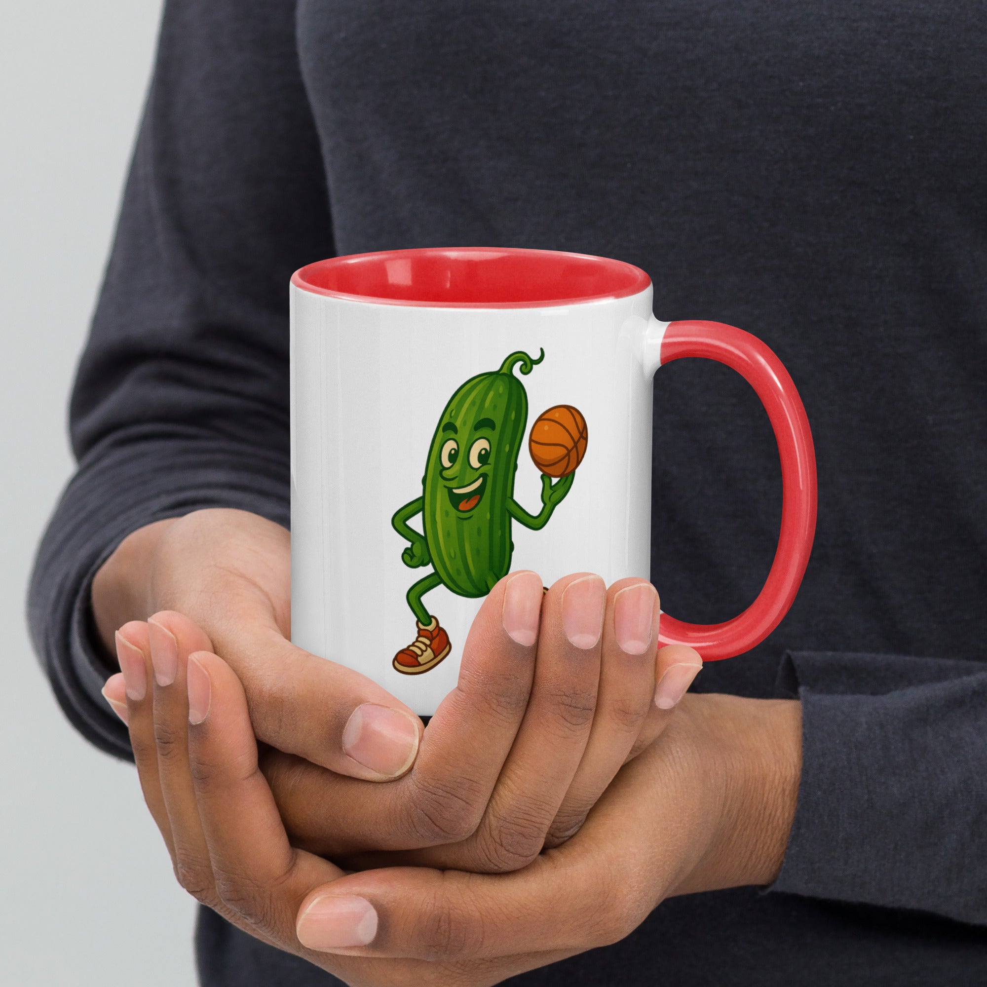 Colorful ceramic mug with a playful pickle character playing basketball, featuring a red handle and rim.