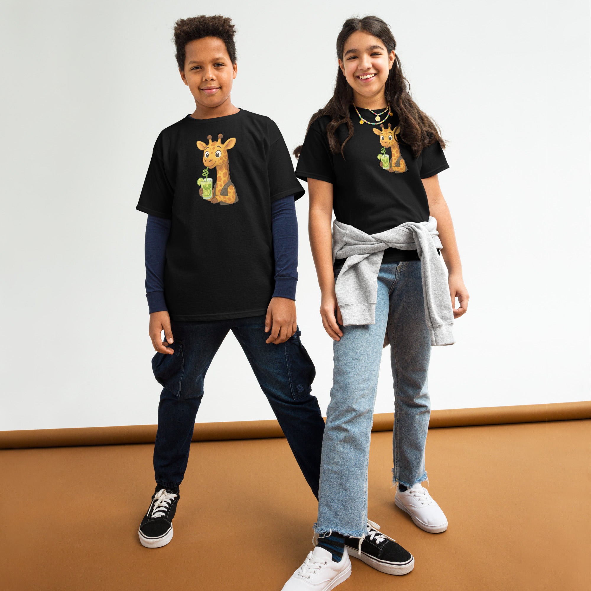 Two children wearing black t-shirts with a giraffe graphic on a white background.